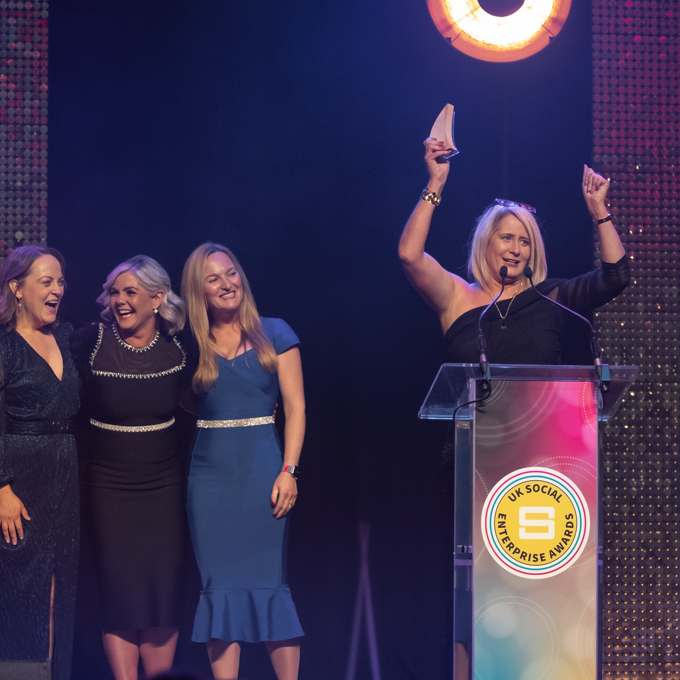 Four women from The Workplace Group celebrate on stage at the 2024 Awards